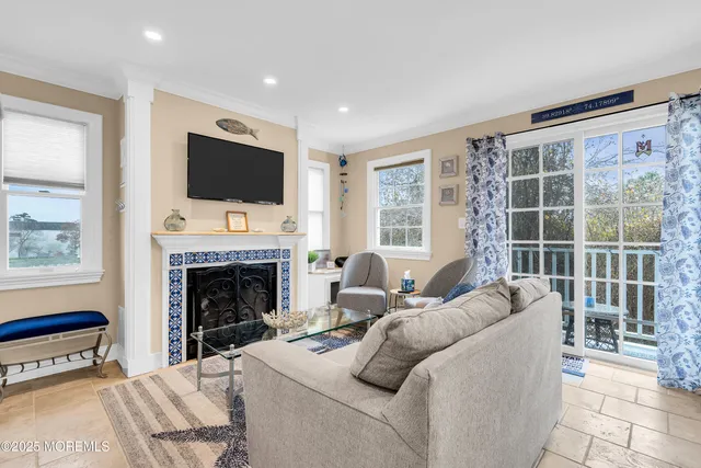 a living room with furniture a flat screen tv and a fireplace