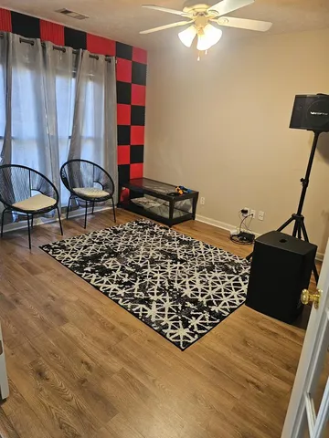 a living room with a couch and a chandelier