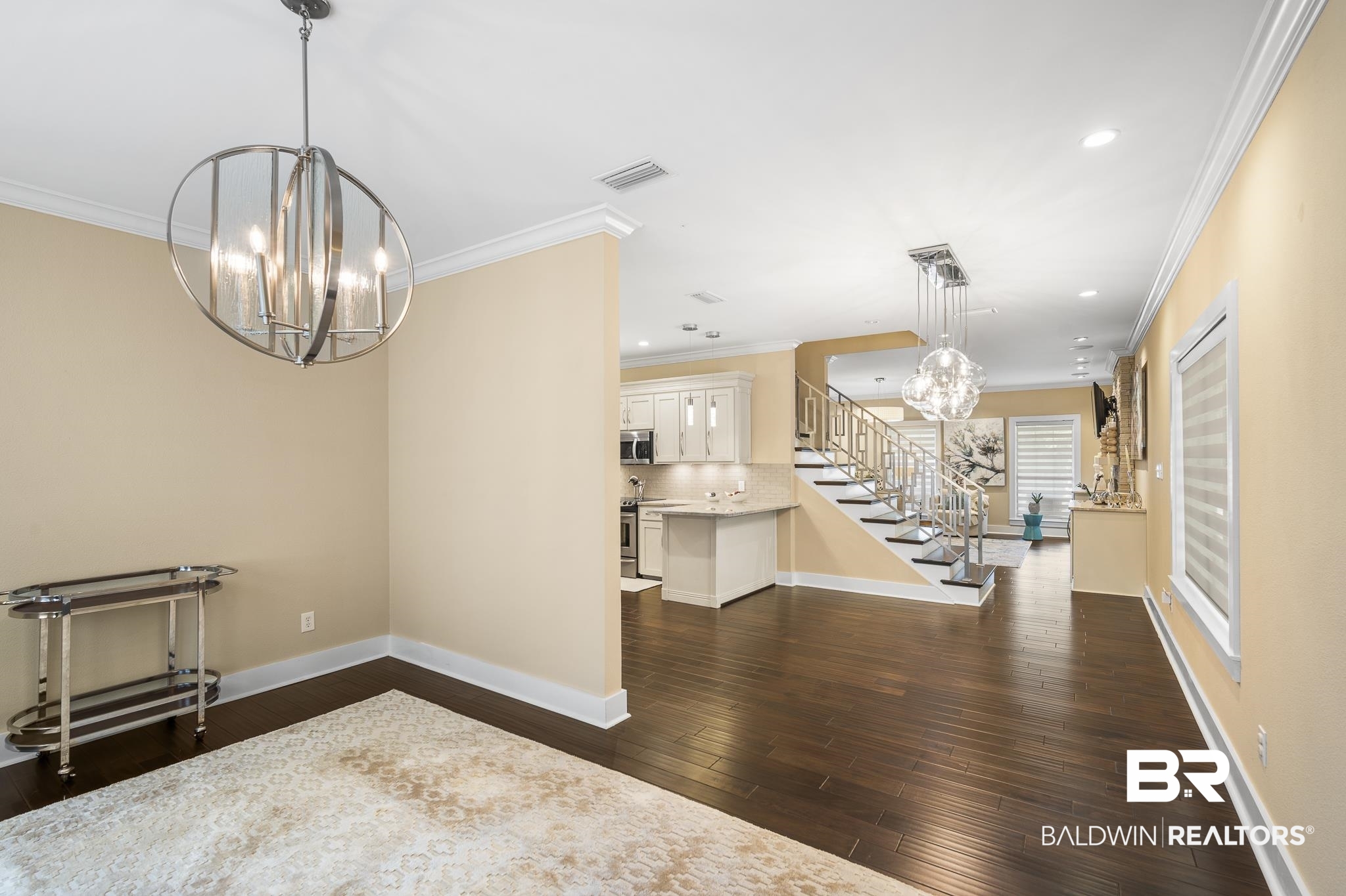 178 Lakeview Loop Daphne, AL 36526 - Photo 20 of 43 Unfurnished dining area featuring a chandelier, ornamental molding, recessed lighting, stairway, and dark wood-style flooring