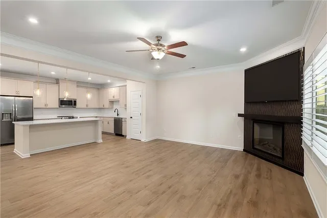 a view of kitchen with microwave and refrigerator