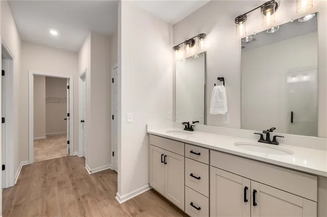 a bathroom with a double vanity sink mirror and shower