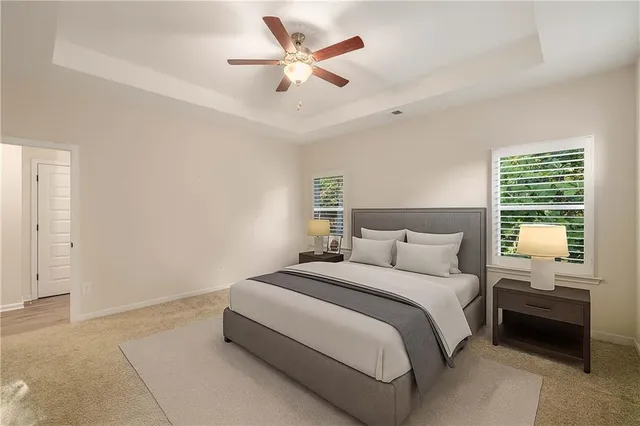 a bedroom with a bed and a large window