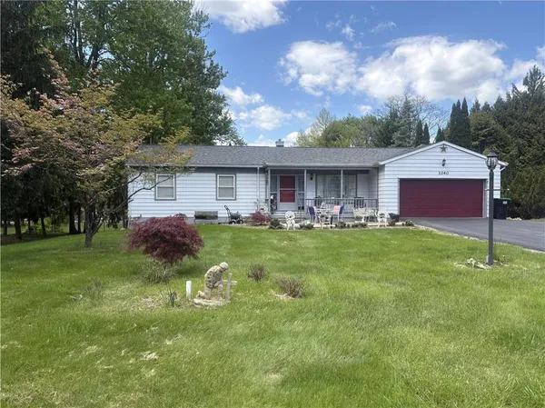 a front view of house with yard and green space