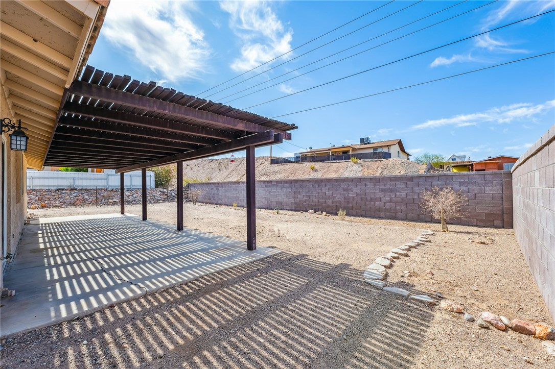 2524 South Ridge Avenue Bullhead City, AZ 86429 - Photo 50 of 64 Fenced backyard featuring a patio