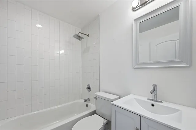 a view of a livingroom with wooden floor and a ceiling fan