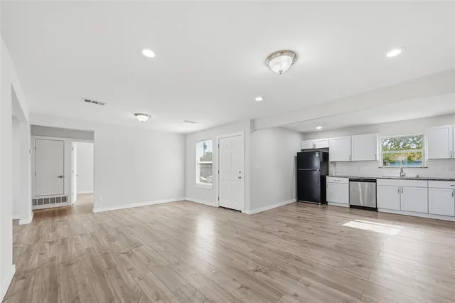 a view of a kitchen with a sink and a stove top oven