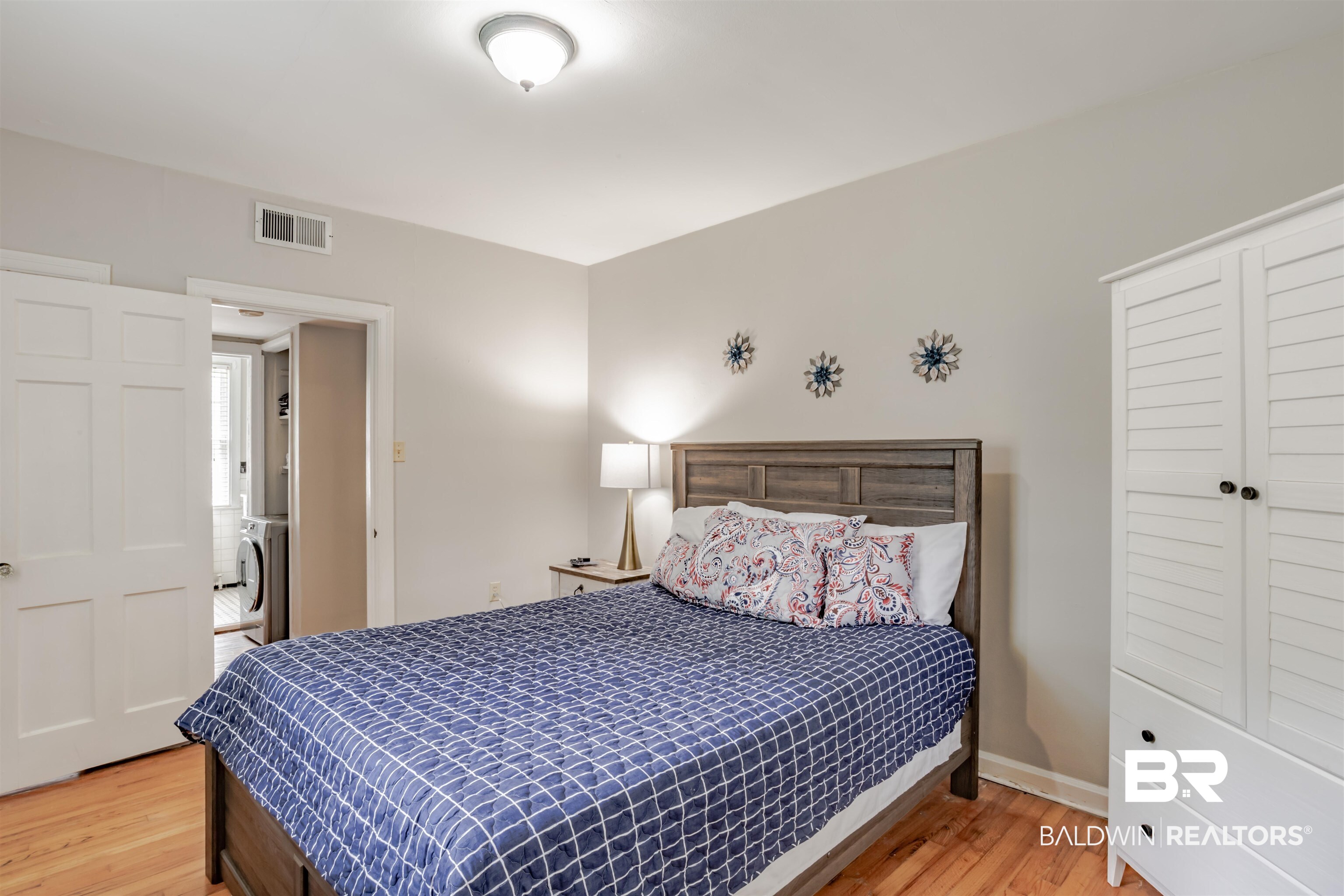 214 Upham Street, Unit 7C Mobile, AL 36607 - Photo 17 of 32 Bedroom with light wood-type flooring and washer / dryer