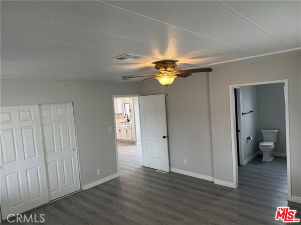 9391 California Avenue, Unit 89 Riverside, CA 92503 - Photo 8 of 16 a view of a room with wooden floor