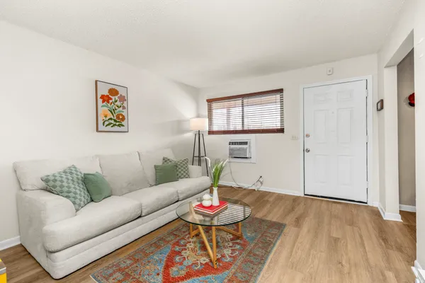 a living room with furniture and wooden floor
