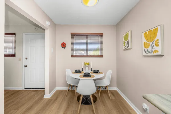 a dining room with furniture and wooden floor