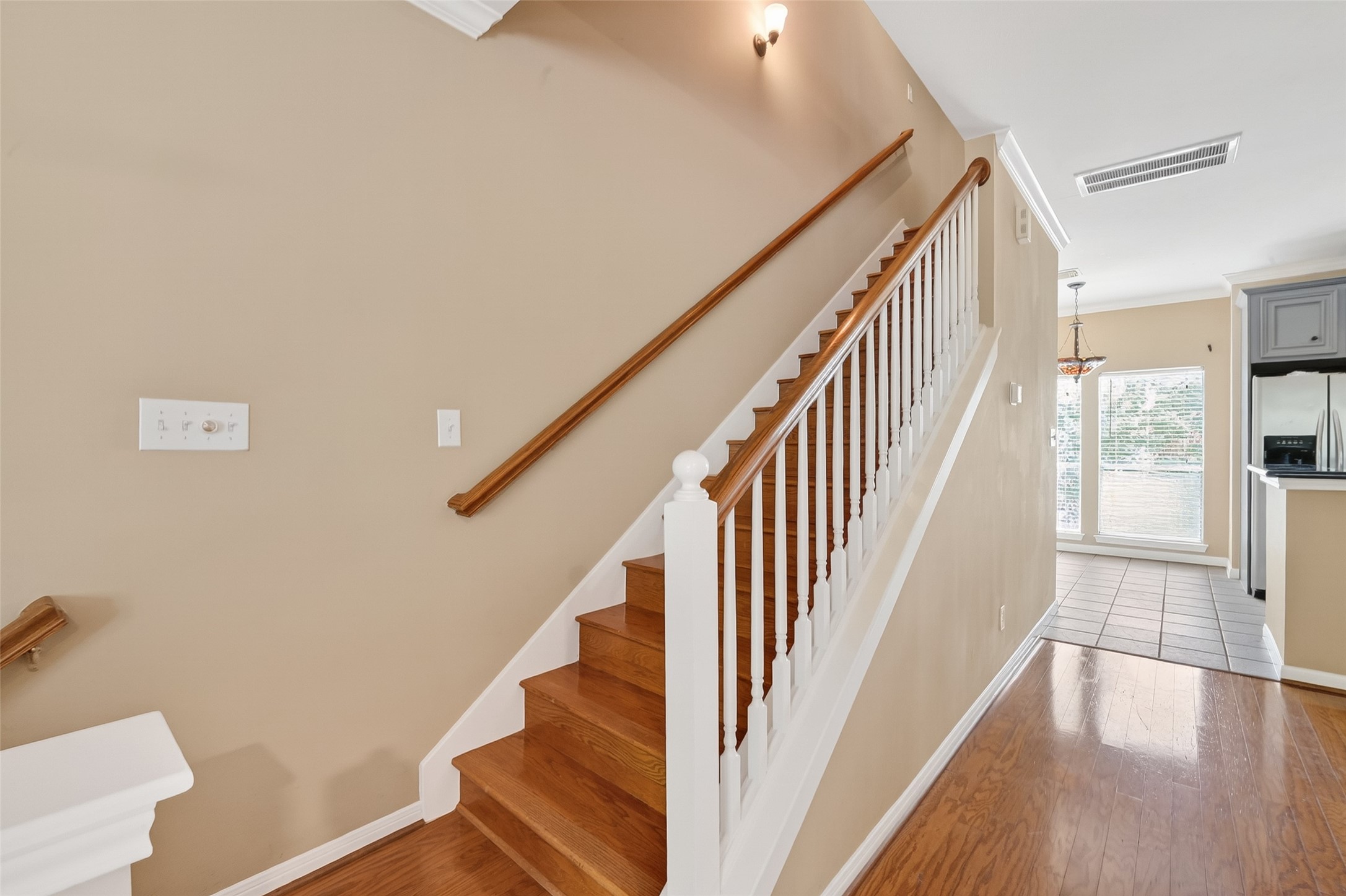 2804 Chenevert Street Houston, TX 77004 - Photo 22 of 37 a view of staircase with lots of frames on wall and wooden floor