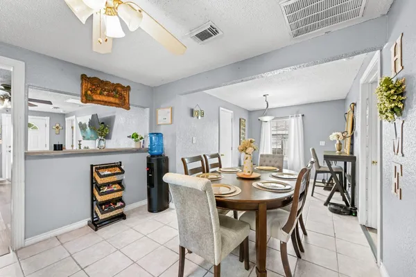 a view of a dining room with furniture and window