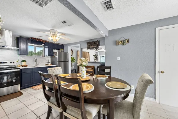 a view of a dining room with furniture and chandelier