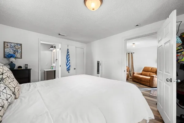 a bedroom with a bed and couch