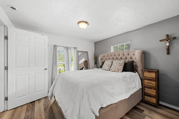 a bedroom with a bed and a window