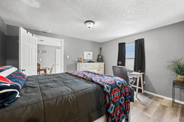 a white bath tub sitting next to a white sink and a window