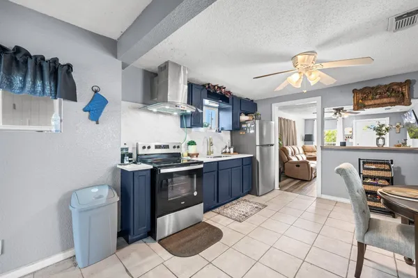 a kitchen with stainless steel appliances kitchen island granite countertop a sink and cabinets