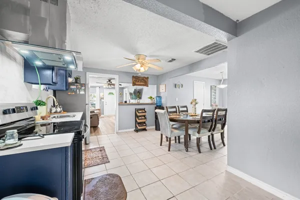 a kitchen with a table and chairs in it