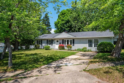 a front view of a house with a garden
