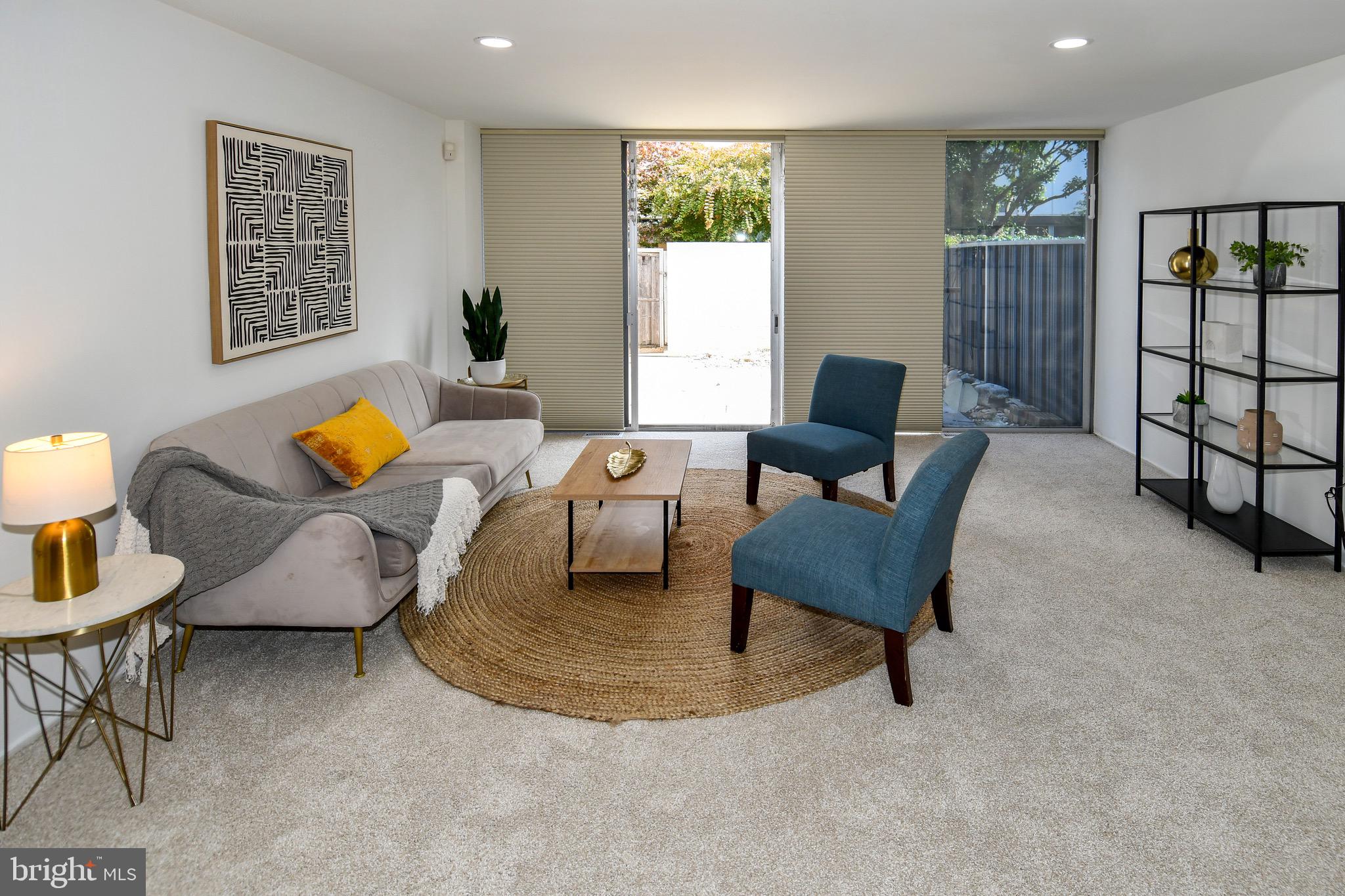 a living room with furniture and painting on the wall