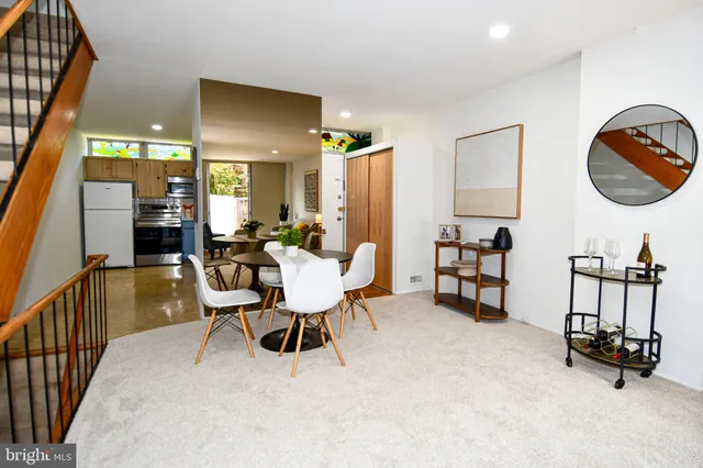 a large bed sitting in a bedroom next to a window