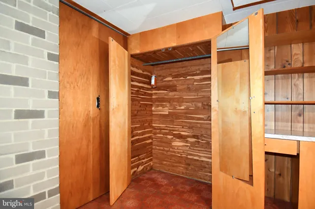 a view of an empty room with cabinet and stairs