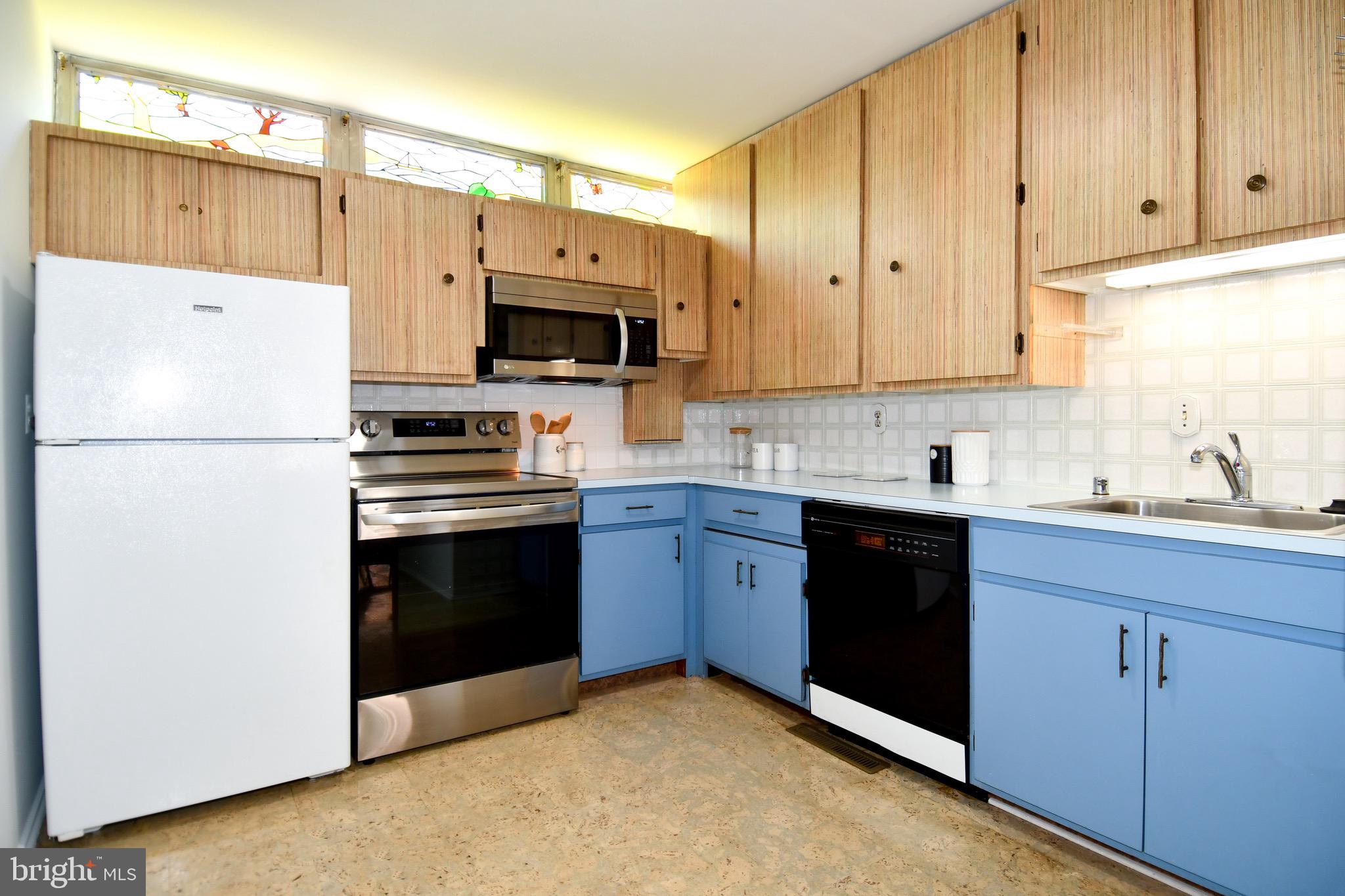 354 N Street Southwest, Unit 354 Washington, DC 20024 - Photo 7 of 48 a kitchen with a refrigerator a stove a microwave and cabinets
