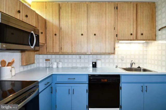 a kitchen with a sink a stove and refrigerator