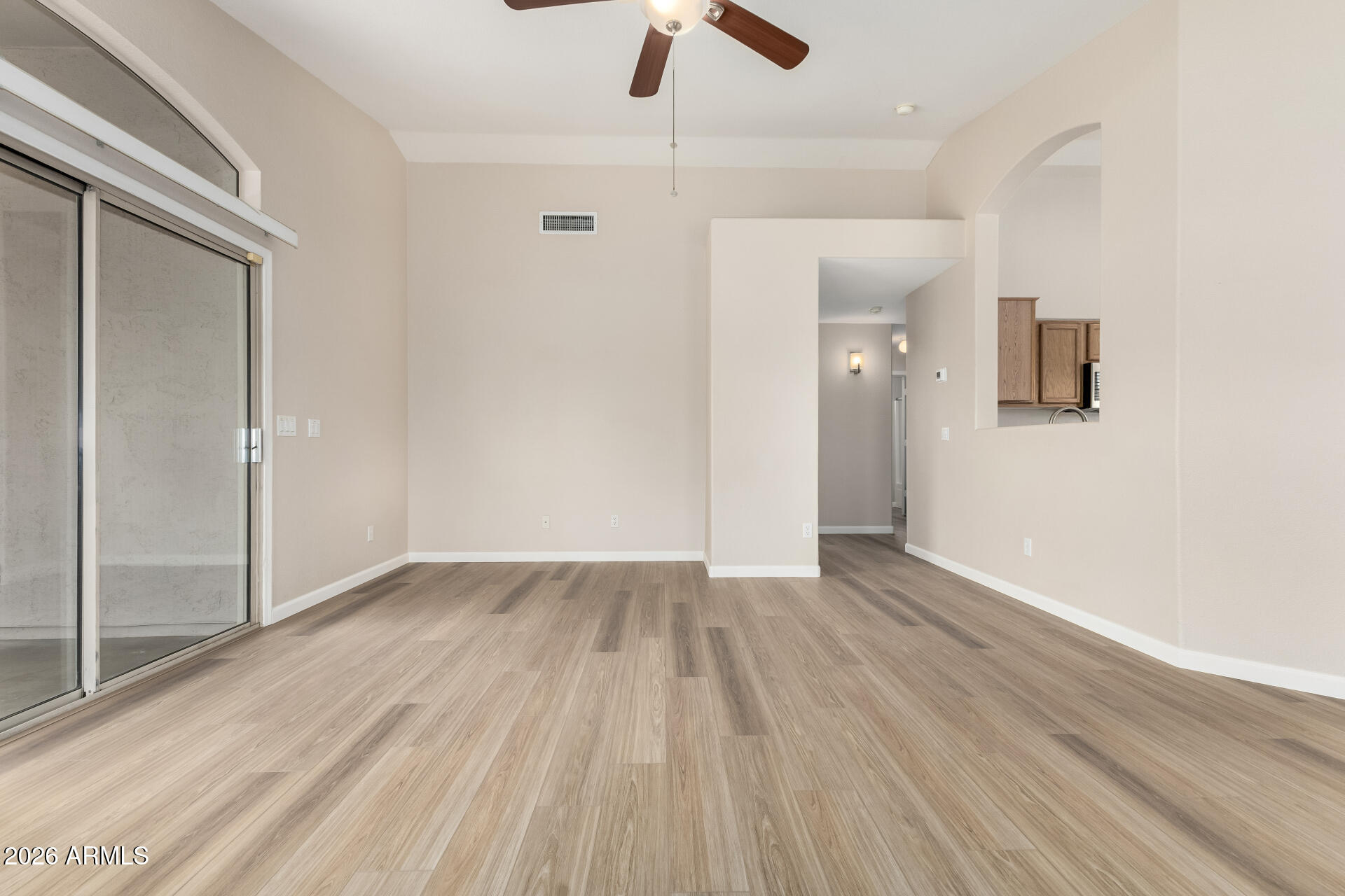 3136 East Desert Lane Gilbert, AZ 85234 - Photo 3 of 22 wooden floor in an empty room with a window