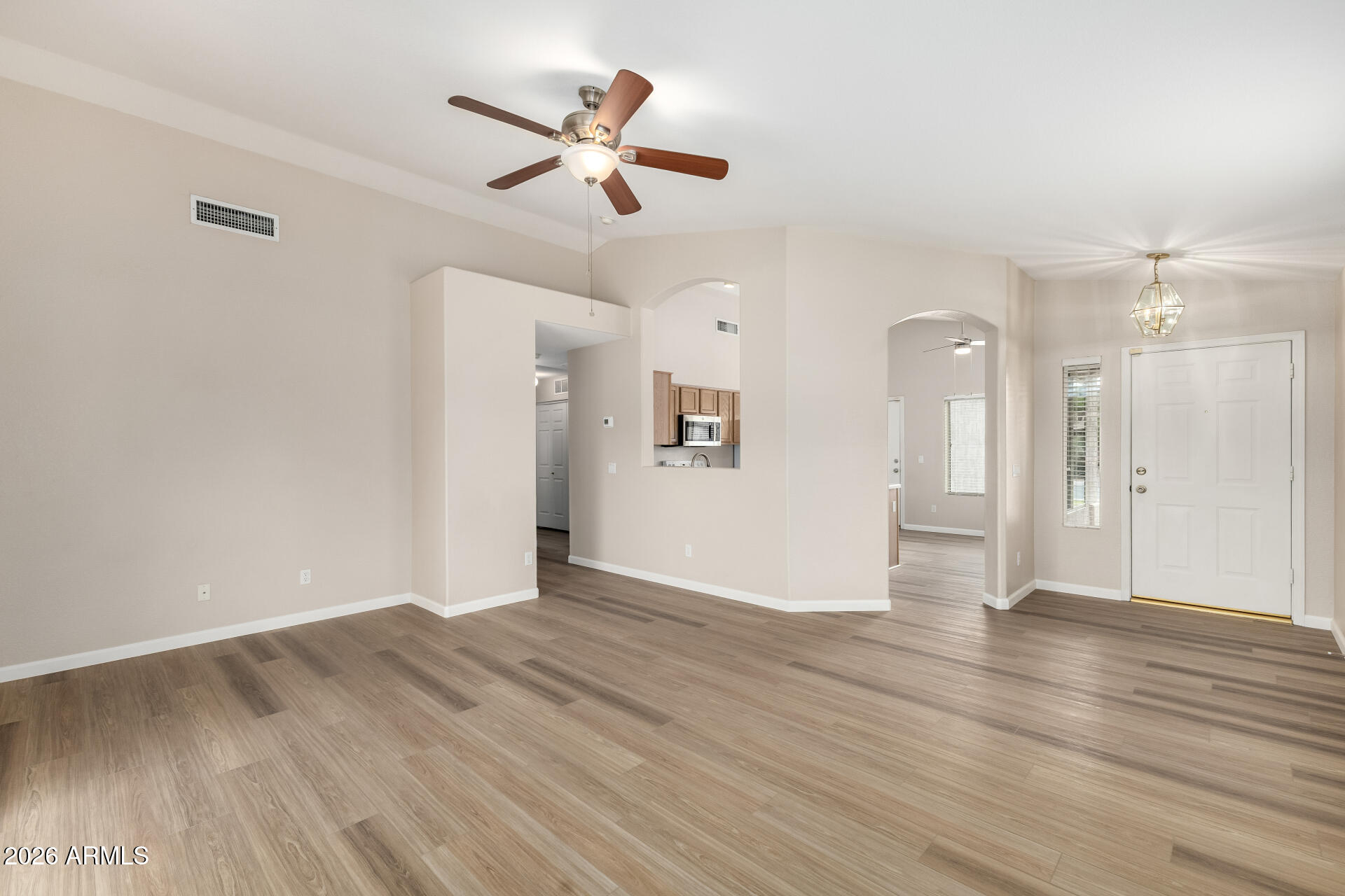 3136 East Desert Lane Gilbert, AZ 85234 - Photo 5 of 22 wooden floor in an empty room with a window