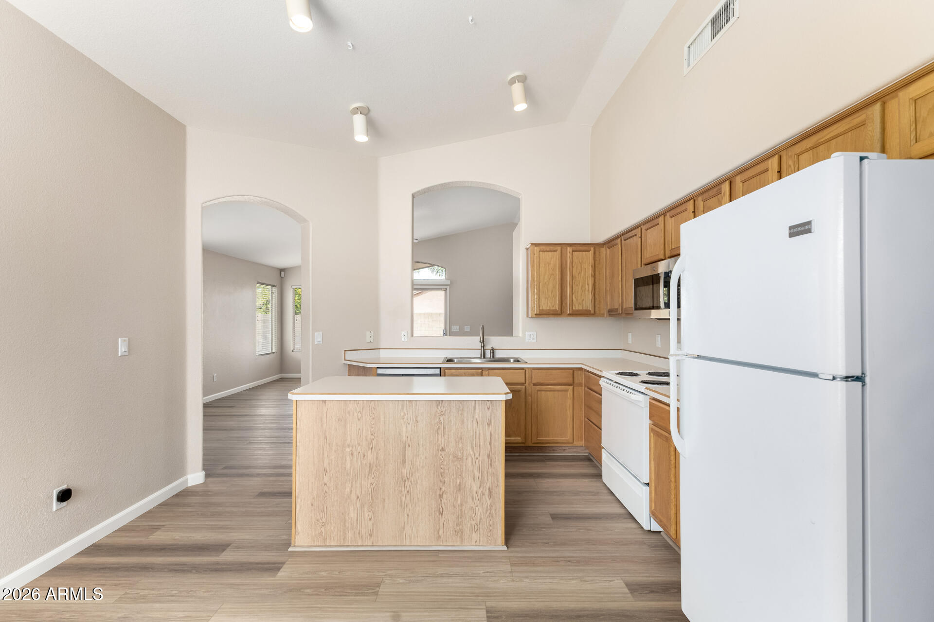 3136 East Desert Lane Gilbert, AZ 85234 - Photo 8 of 22 a kitchen with a refrigerator a stove top oven and a sink