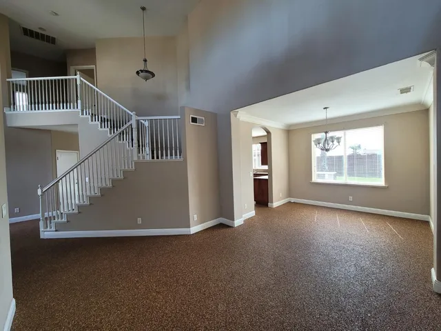 a view of an empty room with stairs