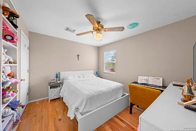 a bedroom with a bed and wooden floor