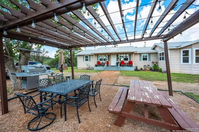 a view of a backyard with furniture porch and wooden floor