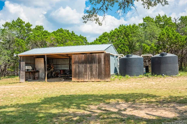 a backyard of a house with table and chairs