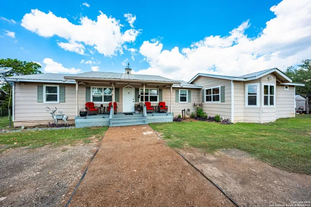a front view of house with yard and green space