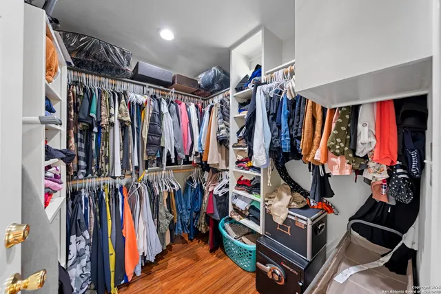 a view of walk in closet with clothes