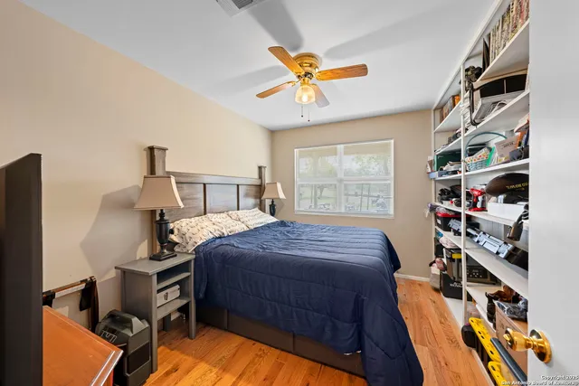 a bedroom with a bed and a book shelf