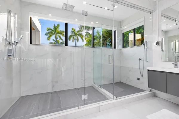 a bathroom with double sink and a mirror