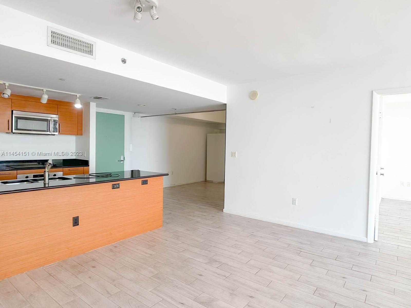 50 Biscayne Boulevard, Unit 3104 Miami, FL 33132 - Photo 11 of 52 a kitchen with stainless steel appliances a refrigerator and a stove