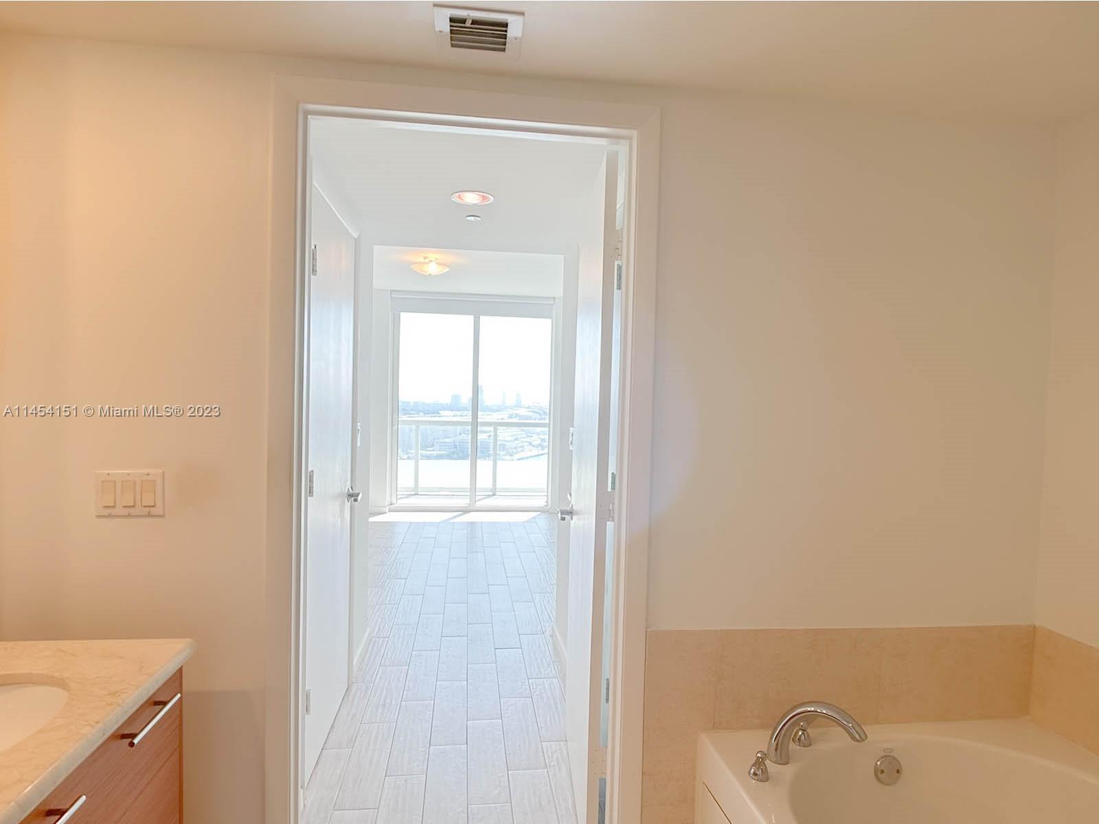 50 Biscayne Boulevard, Unit 3104 Miami, FL 33132 - Photo 22 of 52 a bathroom with a bathtub and a shower
