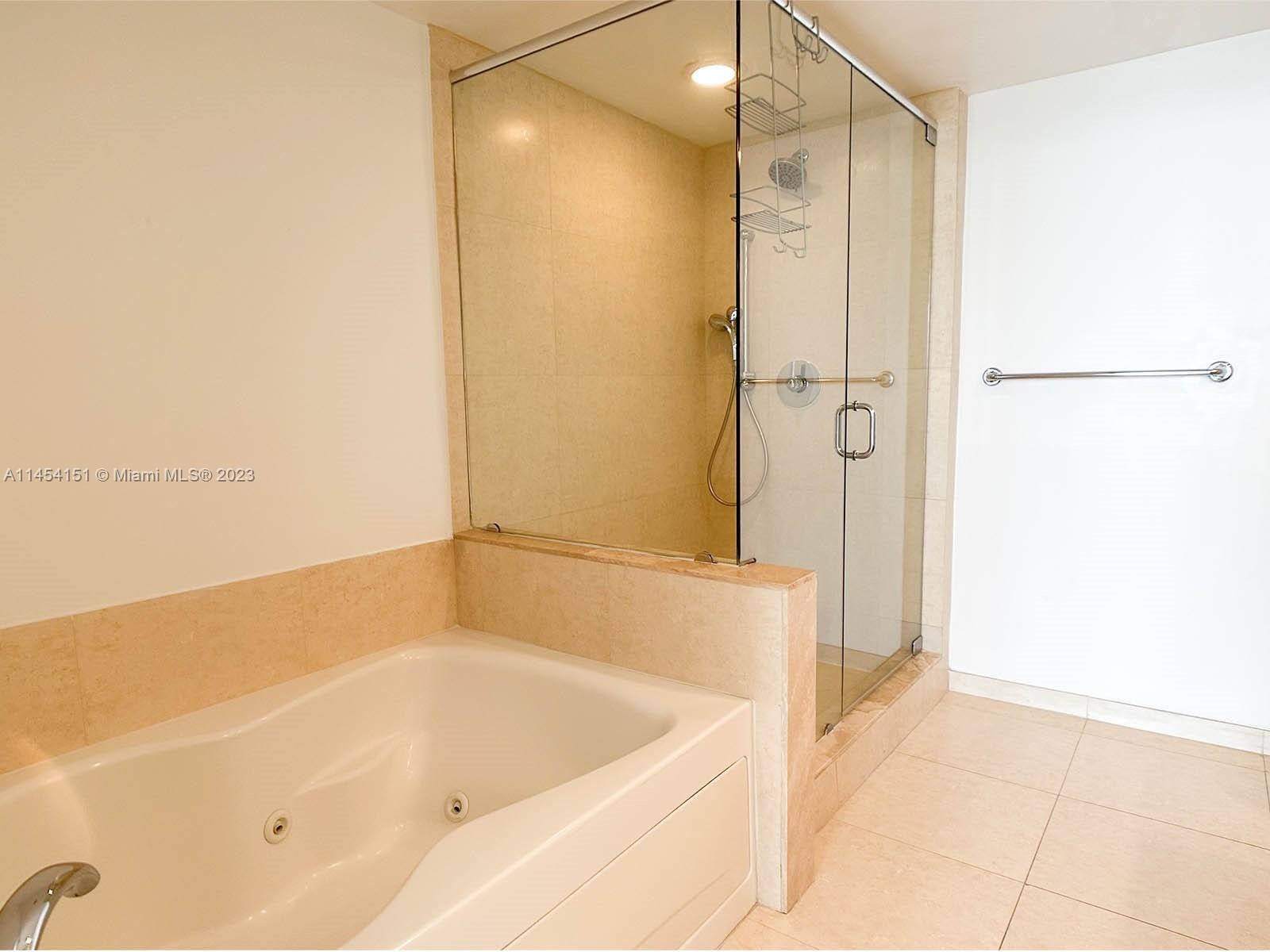 50 Biscayne Boulevard, Unit 3104 Miami, FL 33132 - Photo 23 of 52 a bathroom with a bathtub and a shower