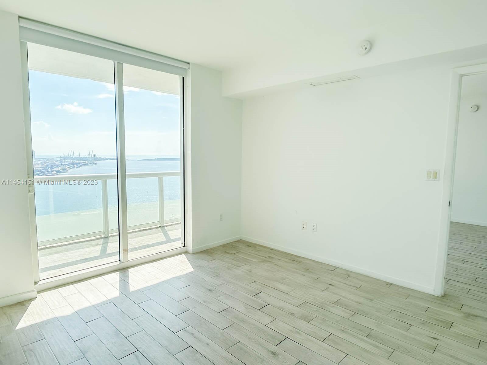 50 Biscayne Boulevard, Unit 3104 Miami, FL 33132 - Photo 26 of 52 an empty room with sliding glass door