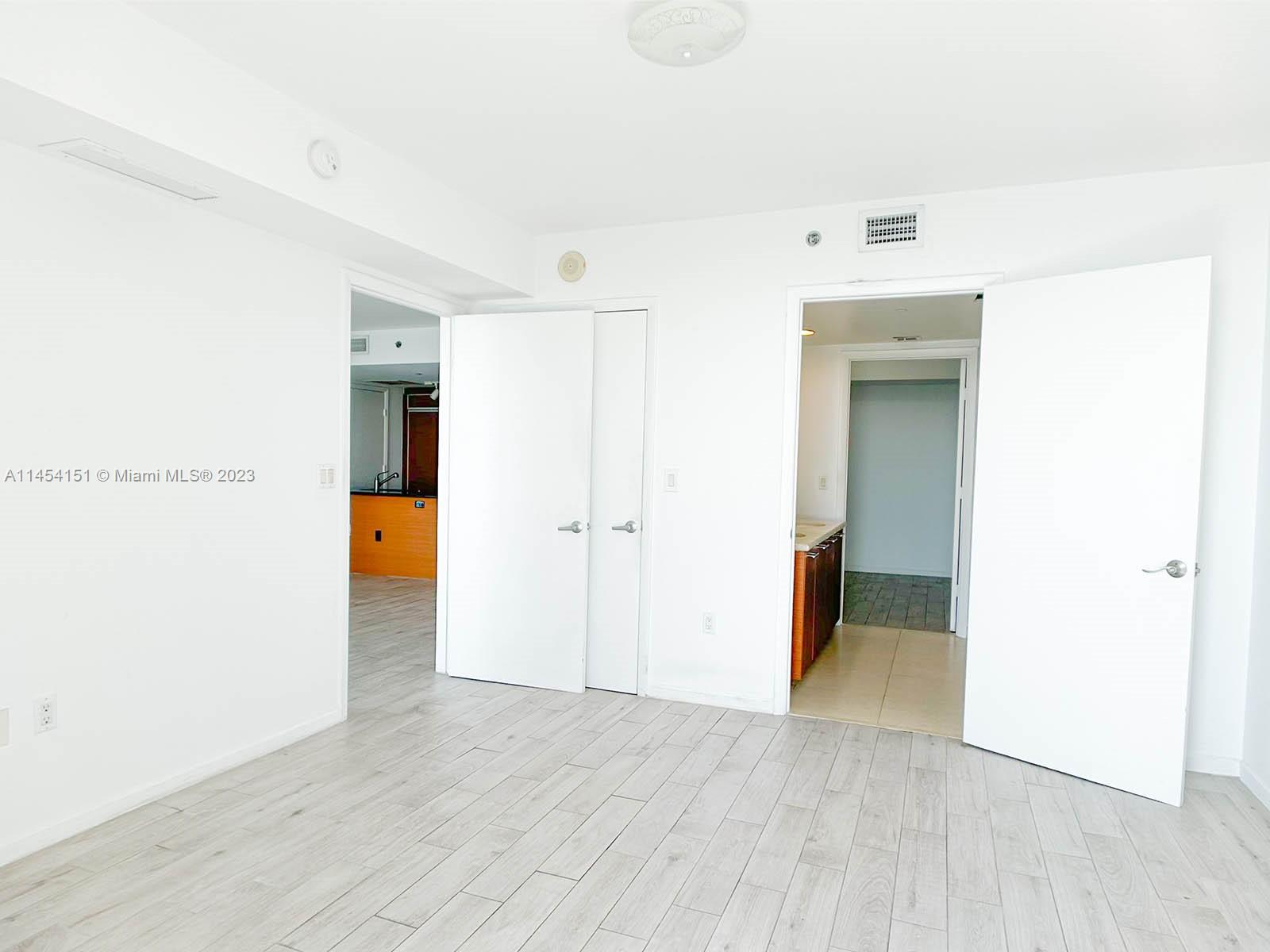 50 Biscayne Boulevard, Unit 3104 Miami, FL 33132 - Photo 28 of 52 a view of a hallway with wooden floor