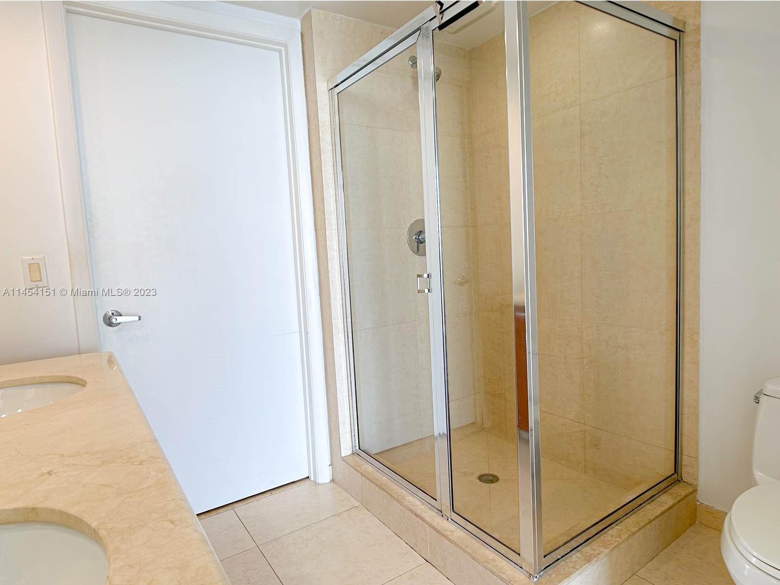 50 Biscayne Boulevard, Unit 3104 Miami, FL 33132 - Photo 32 of 52 a bathroom that has a glass shower door