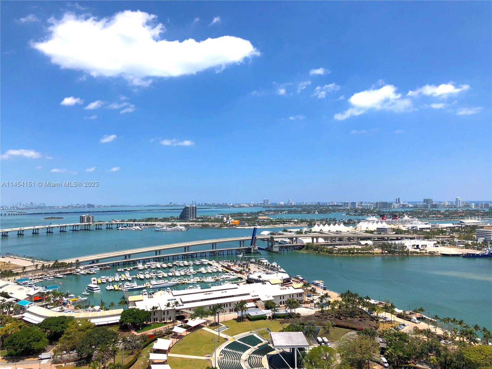 50 Biscayne Boulevard, Unit 3104 Miami, FL 33132 - Photo 36 of 52 a view of a city with lots of boats and trees in the background