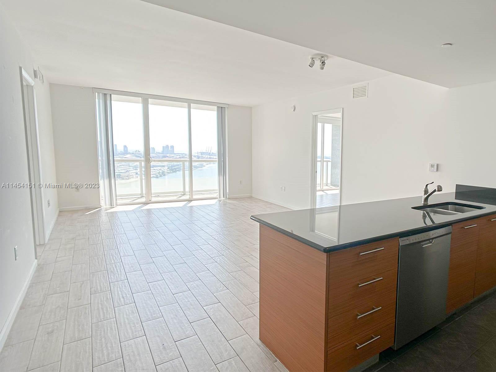 50 Biscayne Boulevard, Unit 3104 Miami, FL 33132 - Photo 5 of 52 a kitchen with a sink and large window