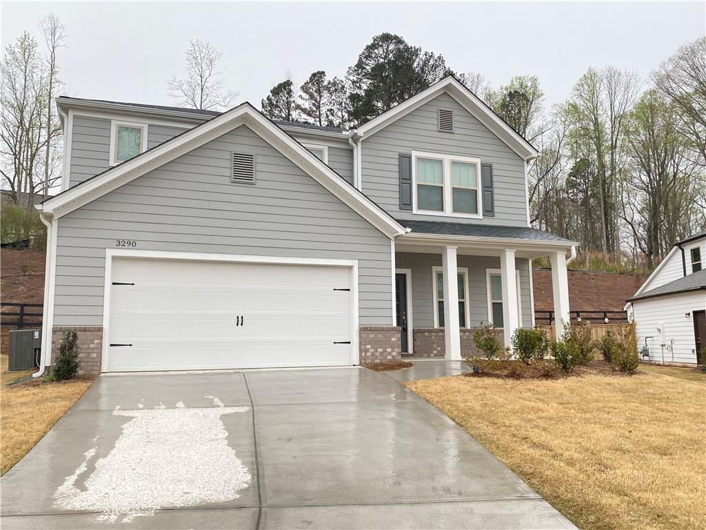 3290 Summerpoint Crossing Cumming, GA 30028 - Photo 2 of 39 a front view of a house with a yard