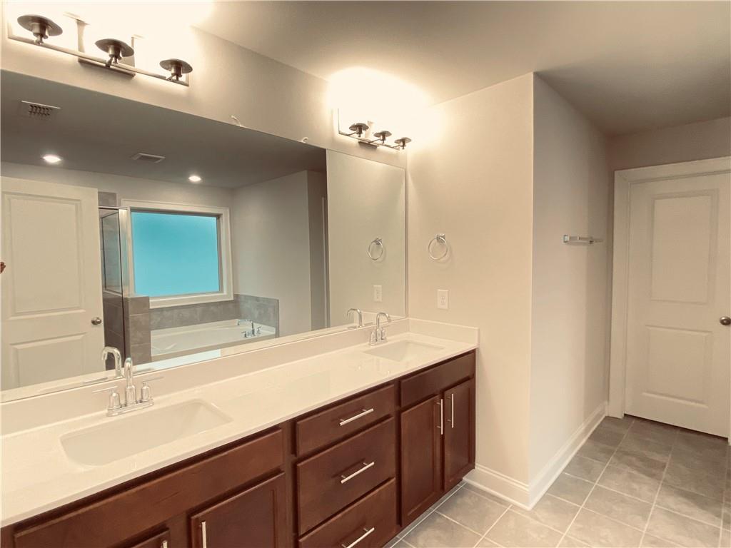 3290 Summerpoint Crossing Cumming, GA 30028 - Photo 22 of 39 a bathroom with a sink double vanity and a mirror