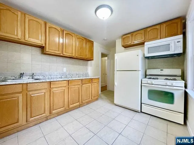 a kitchen with stainless steel appliances granite countertop a refrigerator sink and cabinets